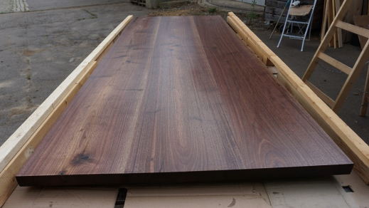 Finished walnut tabletop on workbench
